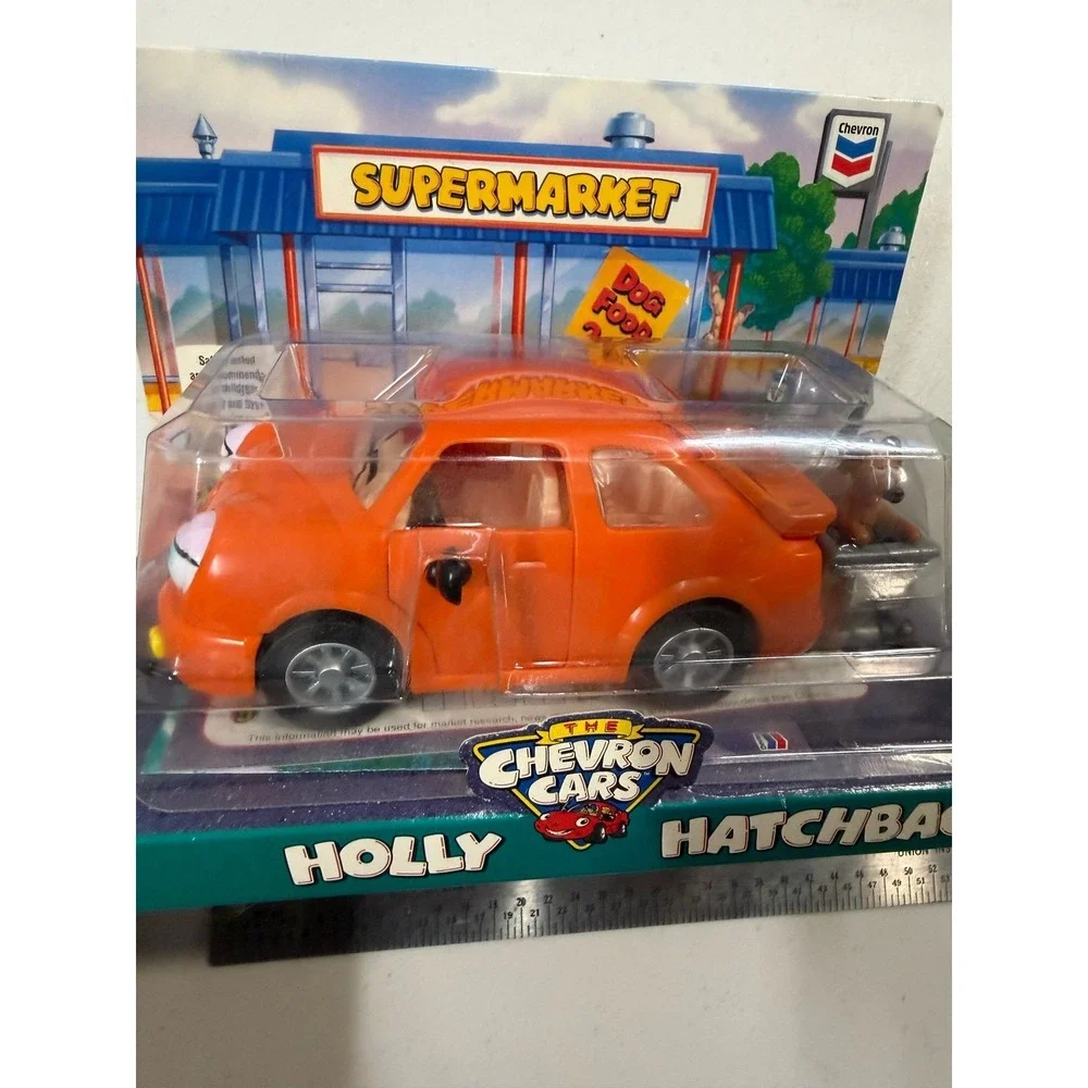 The Chevron Cars Holly Hatchback Orange Toy Car with Dog and Shopping Cart 1997